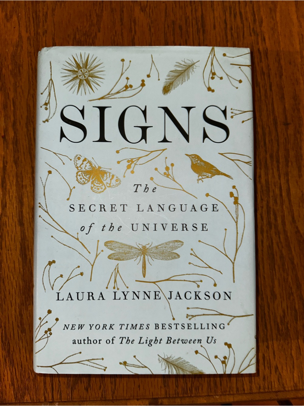 Signs hardcover book with gold botanical accents